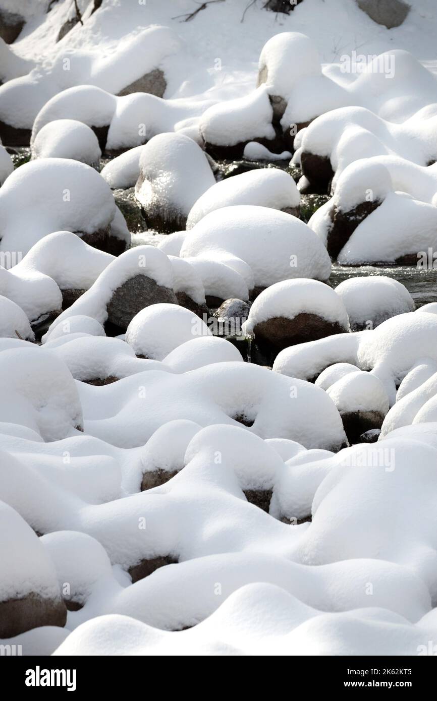 Paysage d'hiver avec pierres enneigées sur la rivière Banque D'Images