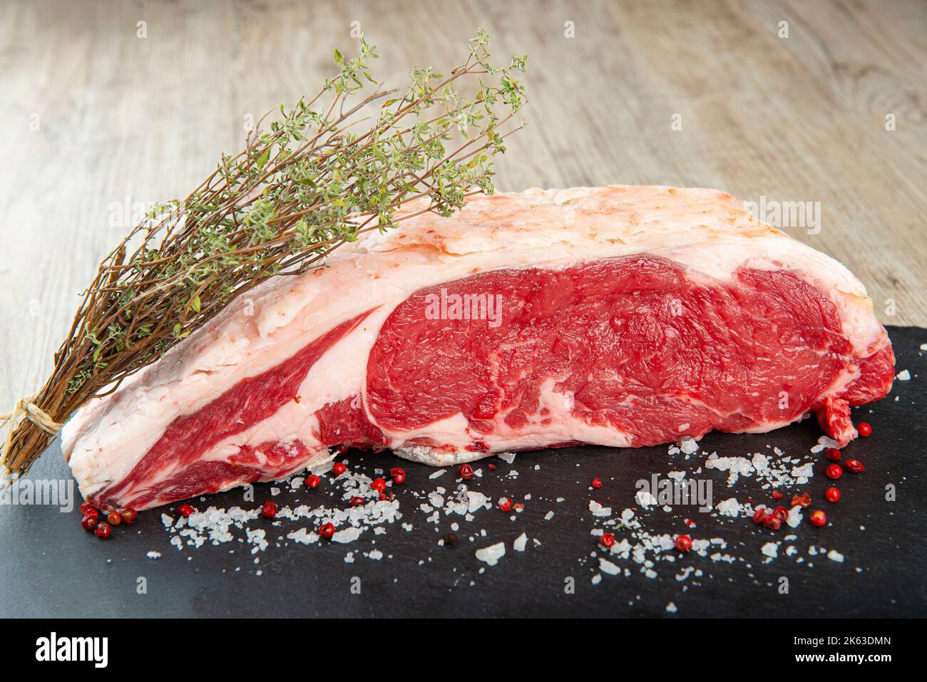 Entrecote cru aux épices sur la table de la cuisine Banque D'Images