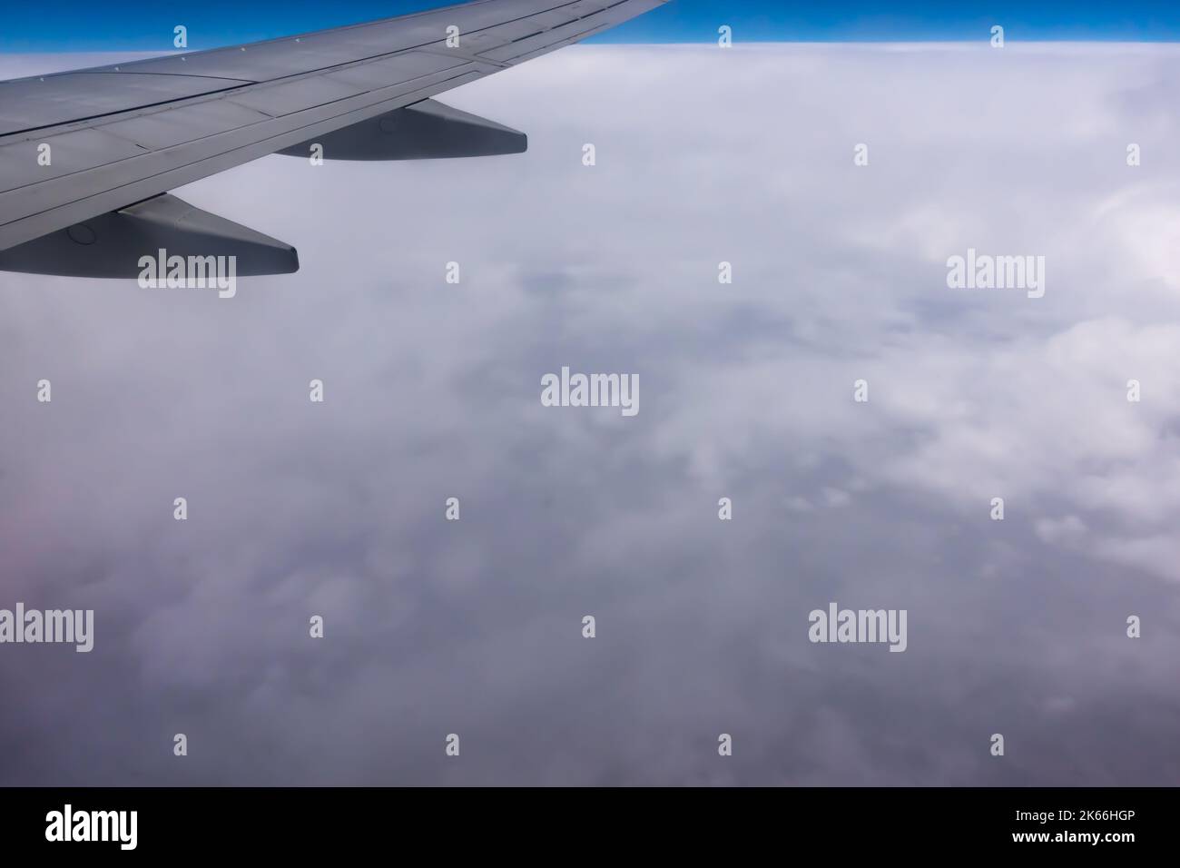 Vue de la fenêtre de plan à l'aile. Photo prise en survolant les nuages. Au loin, un horizon visible fait de nuages Banque D'Images