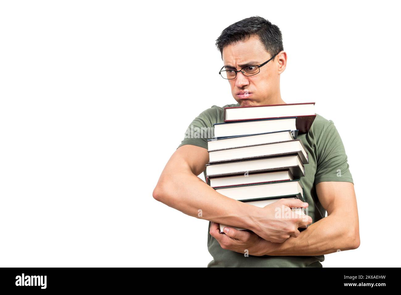 Un étudiant fatigué portant une pile de livres Banque D'Images