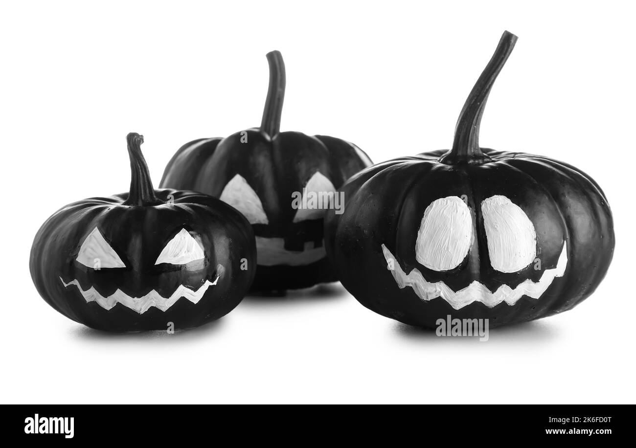 Citrouilles d'Halloween noires avec visage dessiné sur fond blanc Banque D'Images