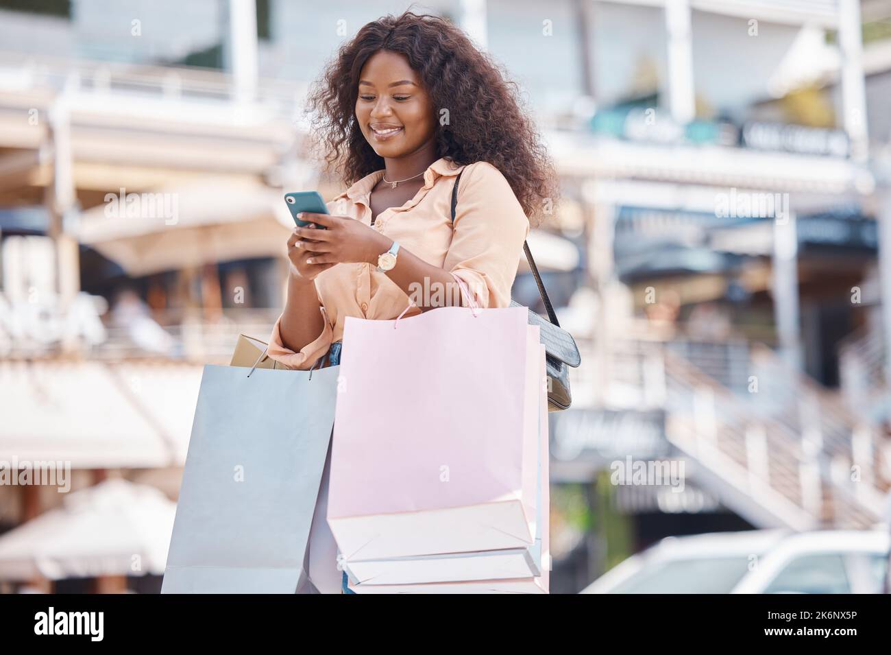 Vente au détail, shopping et téléphone avec une femme en ville pour la technologie, les médias sociaux et le mode de vie de communication. Contact, affaire et mobile avec la fille heureuse Banque D'Images