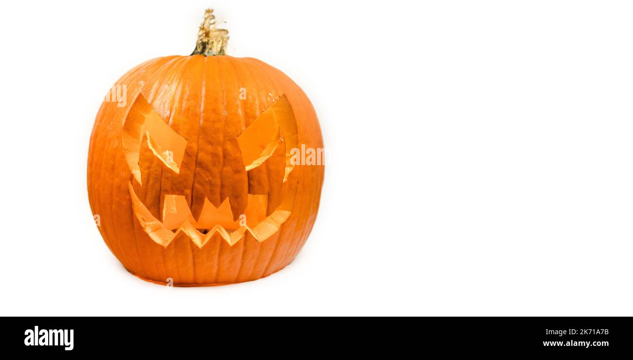 Véritable Halloween orange citrouille bannière blanche d'arrière-plan donnant des vibes effrayantes de saison. Portrait de la tête de citrouille effrayant illuminant à l'intérieur avec des lumières orange, octobre Banque D'Images