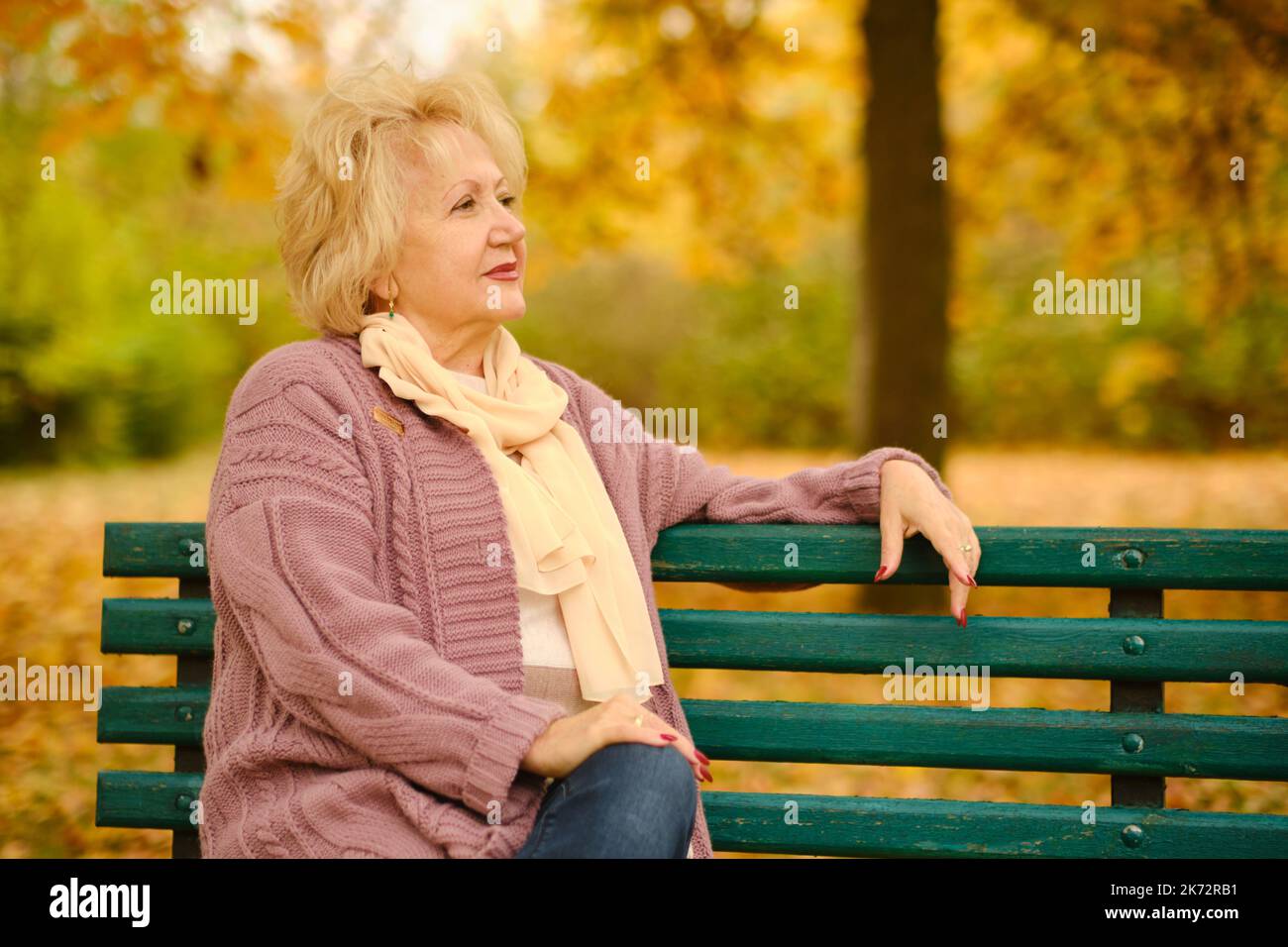 portrait d'une grand-mère heureuse sur un banc de parc Banque D'Images