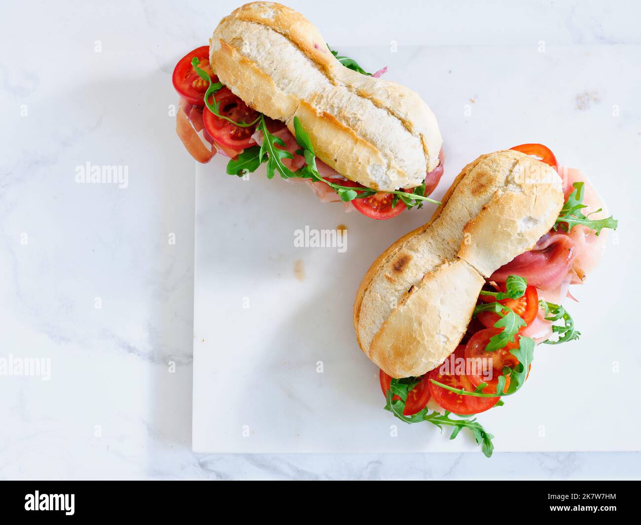 Plat avec de savoureux sandwiches au jambon, mozarella et légumes frais. Concept déjeuner simple. Espace de texte Banque D'Images