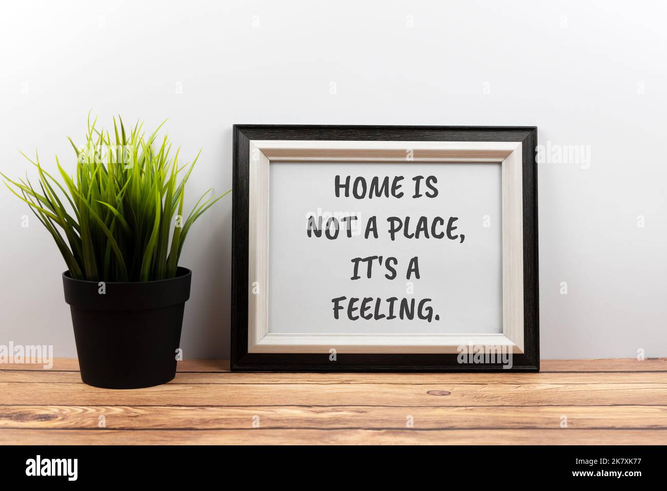 Texte de citations inspirantes dans un cadre - la maison n'est pas un lieu, c'est un sentiment. Banque D'Images
