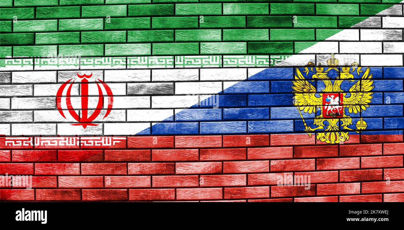 Drapeau de la Russie et de l'Iran sur un mur de briques. Concept de coopération entre deux pays Banque D'Images