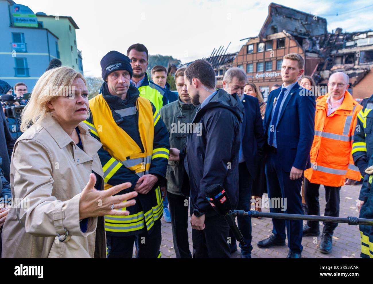 Allemagne. 20th octobre 2022. 20 octobre 2022, Mecklembourg-Poméranie occidentale, Groß Strömkendorf: Nancy Faeser (SPD), ministre fédérale de l'intérieur, parle devant l'hôtel brûlé avec des pompiers qui ont été impliqués dans les travaux de sauvetage. Le bâtiment, qui abritait des réfugiés d'Ukraine, a brûlé la nuit dernière. Personne n'a été blessé dans l'incendie, on soupçonne un incendie criminel. Les 14 résidents ont été logés dans d'autres appartements après les travaux de sauvetage. Photo: Jens Büttner/dpa crédit: dpa Picture Alliance/Alay Live News Banque D'Images