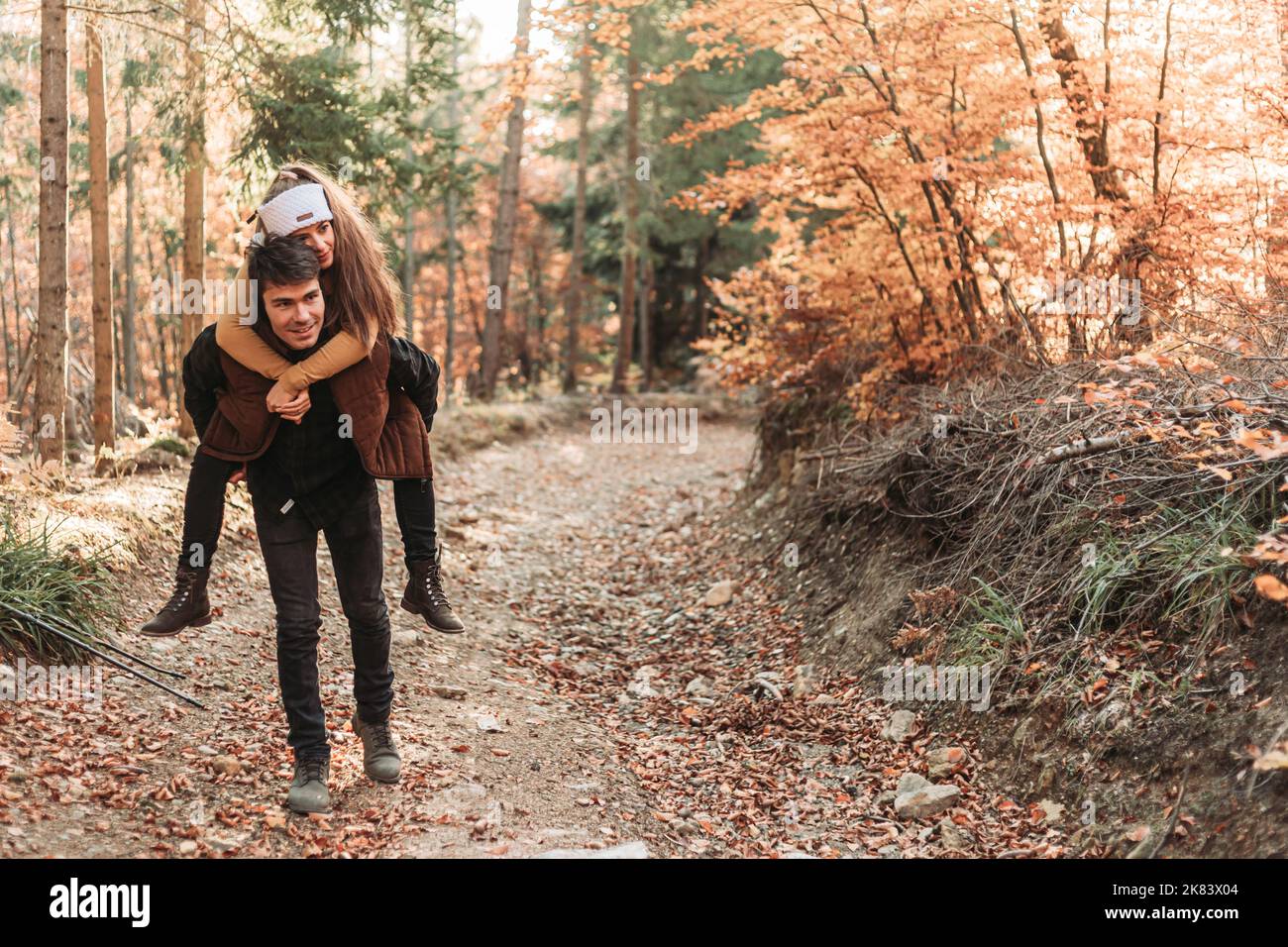 Jeune couple romantique dans les bois.Promenade en pigeyback.Heureux ensemble Banque D'Images