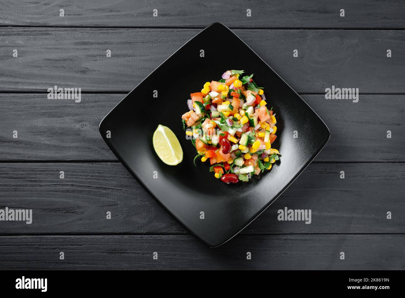 Caviar de cowboy maison avec des haricots de maïs, des poivrons de lime et des légumes. Cuisine texane sur fond noir vue du dessus Banque D'Images