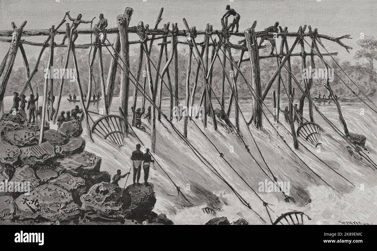 Les pêcheurs Wagenya préparent leurs trépieds en bois sur les rapides de la rivière à Stanley Falls. Banque D'Images