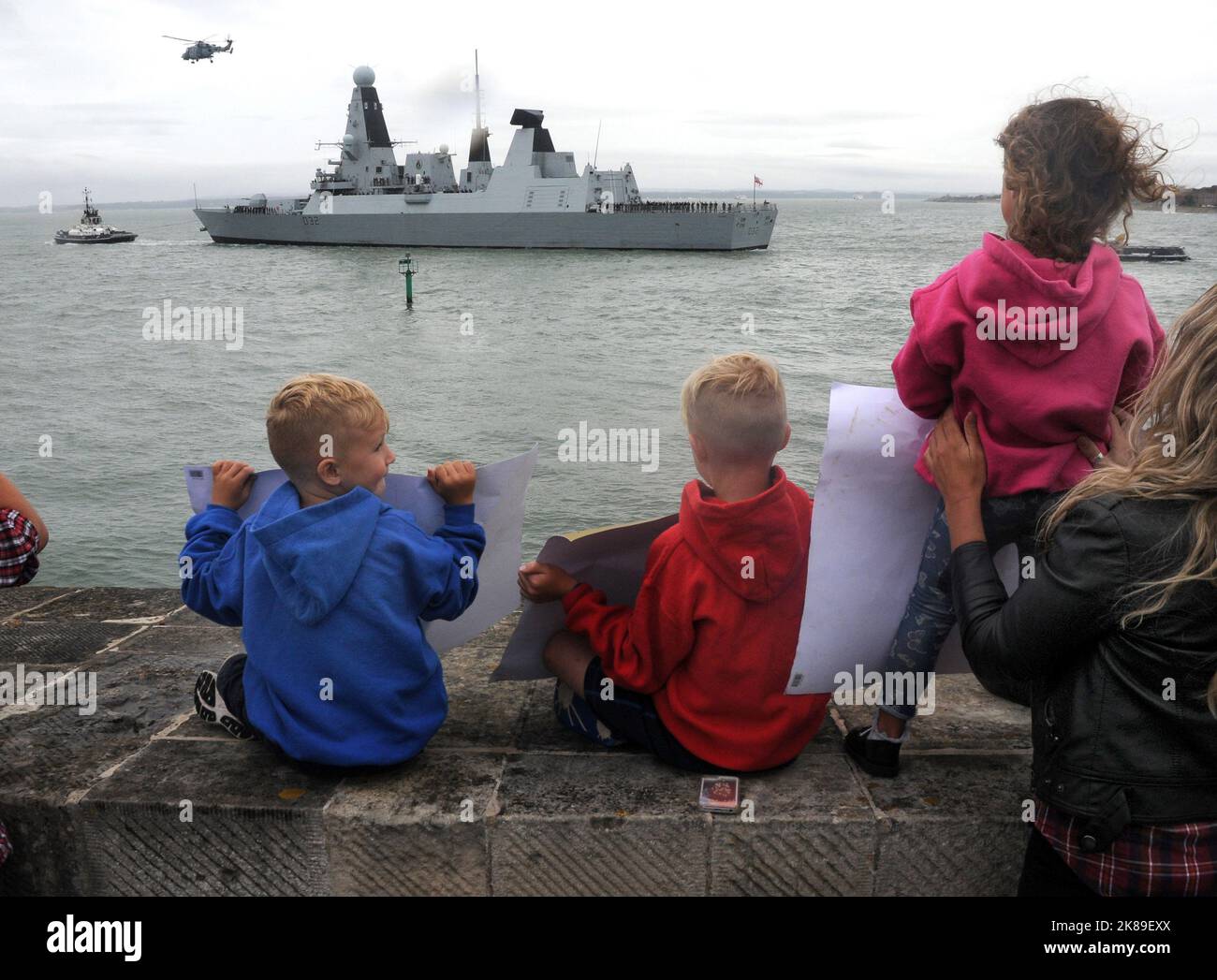 Jude Neslon, 7 ans, son frère Austin, 5 ans, et Katie Mobius, 3 ans, montrent leurs affiches tandis que leur père Robert Nelson sort de Portsmouth à bord du HMS Ardening. Pic Mike Walker,2016 Mike Walker photos Banque D'Images