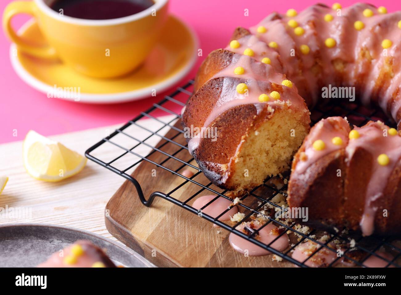 gâteau d'anniversaire brillant. délicieux gâteau au citron avec glaçage rose sur fond rose Banque D'Images