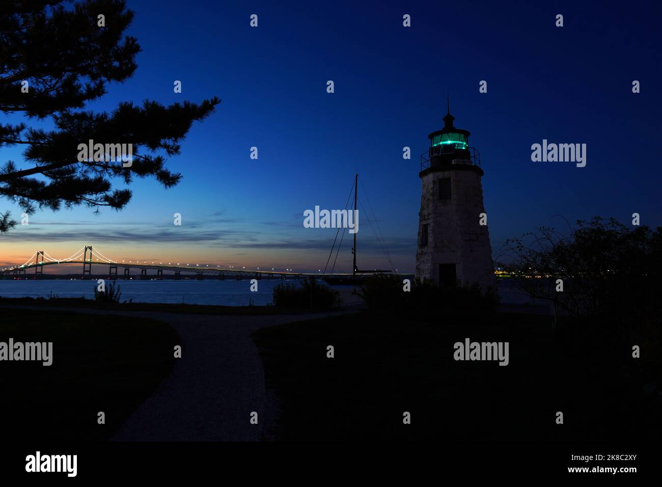Phare de Goat Island avec le Newport Bridge en arrière-plan au crépuscule à Rhode Island Banque D'Images