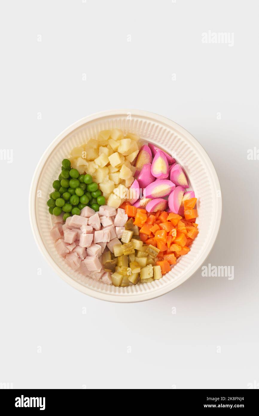 Ingrédients pour salade Olivier dans un bol sur fond blanc Banque D'Images