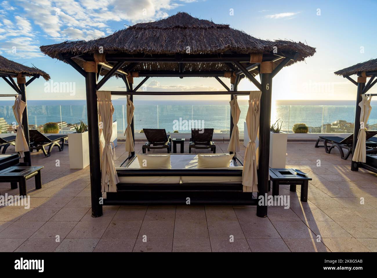 Lits balinais sur la terrasse donnant sur l'océan comme thème de vacances Banque D'Images