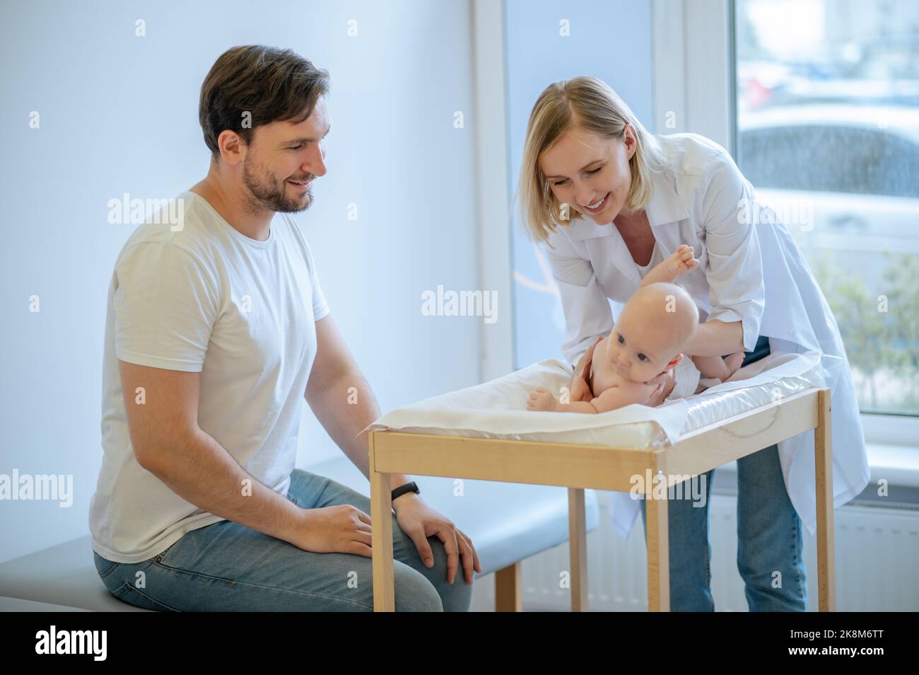 Un médecin pédiatrique teste les réflexes du nouveau-né Banque D'Images