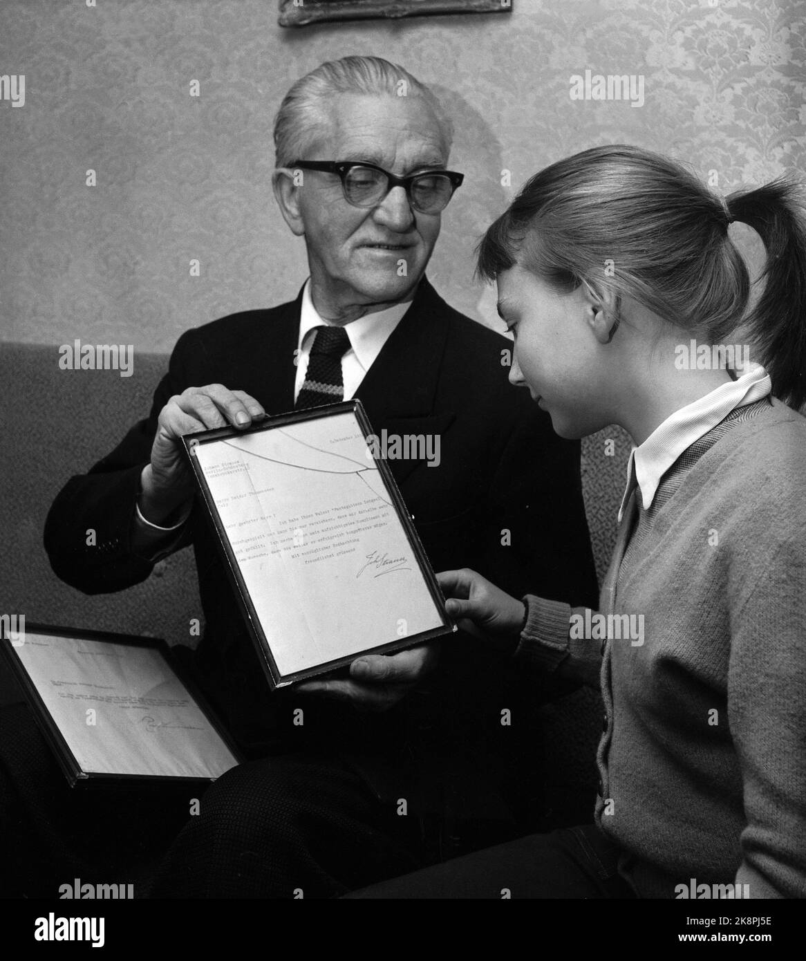 Oslo 195704 compositeur Reidar Thommessen (1889-1986) presque 50 ans après avoir composé "c'était un rêve" ou le rouleau clair de lune que beaucoup le savent qui, il était prêt à participer à la mélodie de ​​series de demain de NRK avec une nouvelle mélodie. La contribution de Thommessen à la compétition a été « quelle sera la fin du spectacle ». Voici Thommessen avec sa fille Laila (12) qui étudie une lettre que Thommessen a dans le verre et le cadre. La lettre est au roi de rouleau norvégien du roi de rouleau Johann Strauss lui-même. Photo: Storløkken / actuel / NTB Banque D'Images