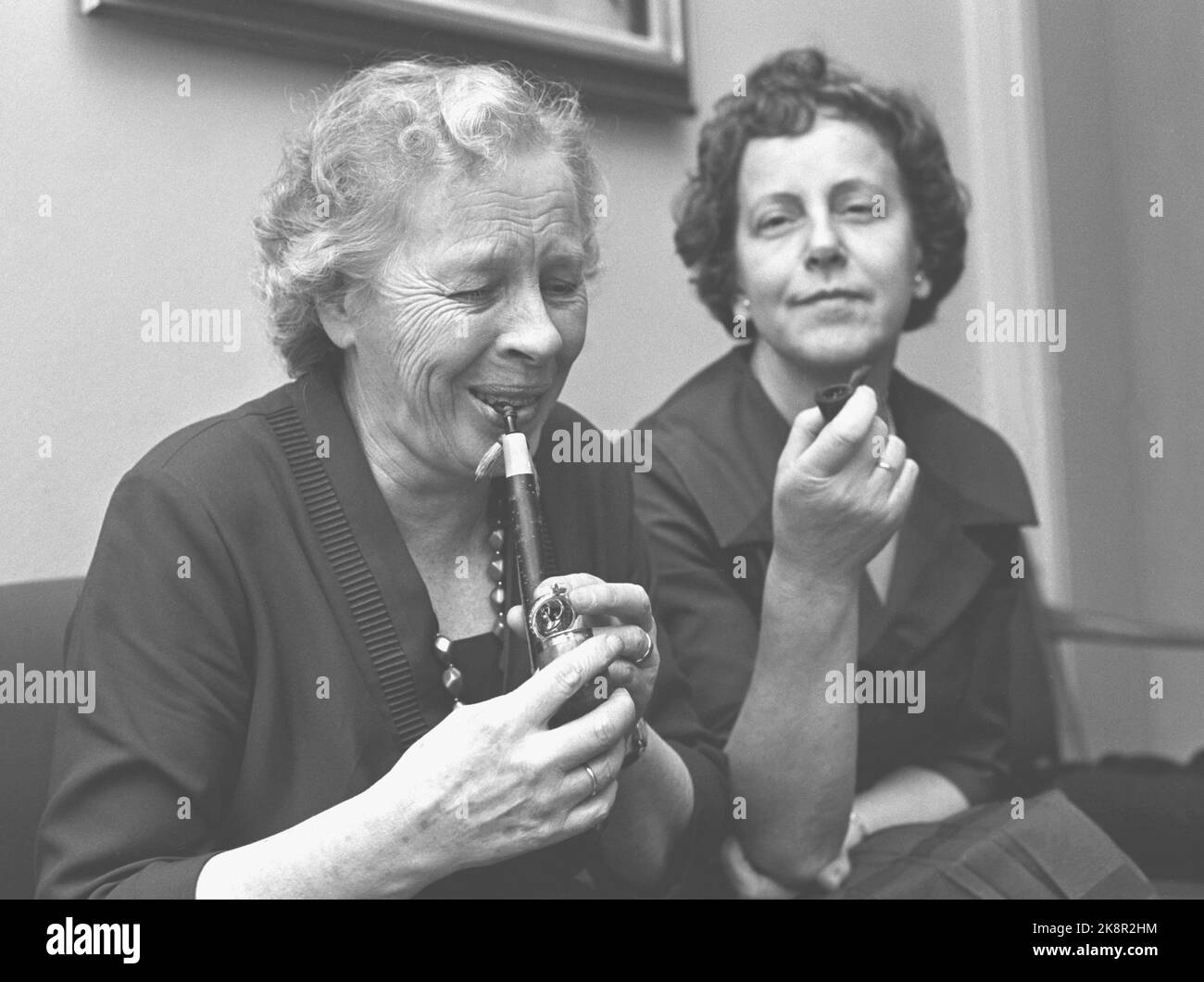 Oslo 19621117. Des tubes d'essai pour femmes célèbres spécialement conçus pour les femmes. Cette année, une usine de tuyaux norvégienne va vendre des bips aux femmes. Par ex. Les femmes parlementaires Haldis Tjernsberg, Hedmark et Guri Johannessen, Buskerud n'étaient pas positives. Le pré-étoilé a pris deux mesures, et a donné leur jugement: TVI, doute maintenant je dois avoir du café. Elle ne fume pas non plus comme d'habitude. Mme Johannessen n'est pas non plus un esclave de nicotine, il y avait donc un piège: Pas de pipe pour les femmes. Photo: Ivar Storløkken Current / NTB Banque D'Images