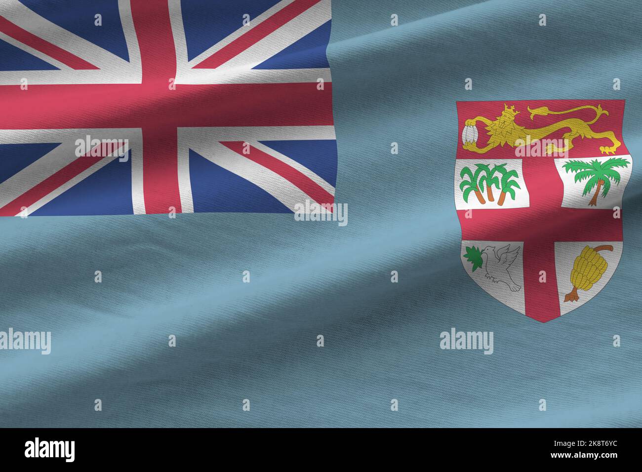 Drapeau des Fidji avec de grands plis et un gros plan sous la lumière du studio à l'intérieur. Les symboles officiels et les couleurs de la bannière en tissu Banque D'Images