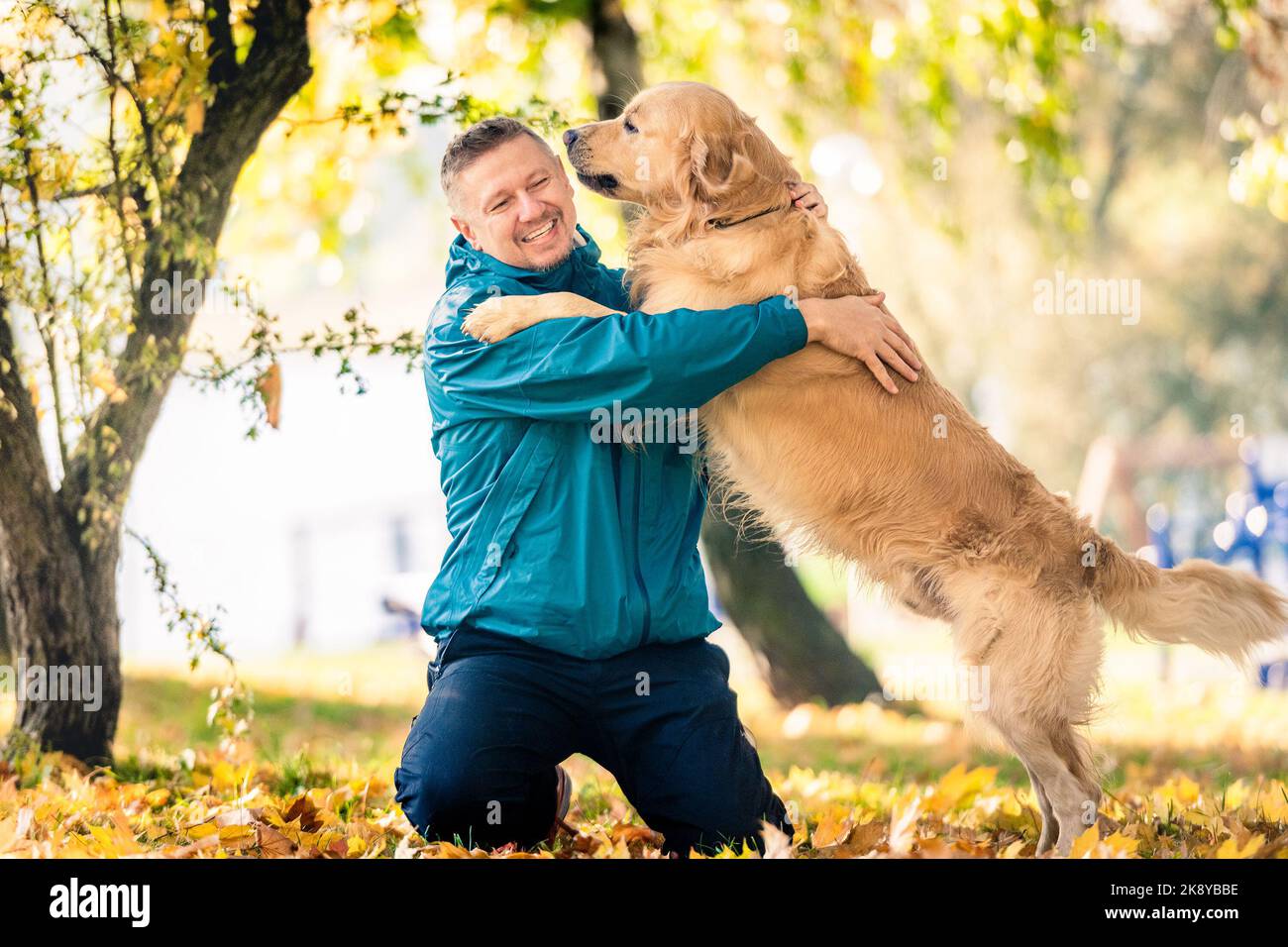 Homme jouant avec son chien Golden Retriever dans le parc Banque D'Images