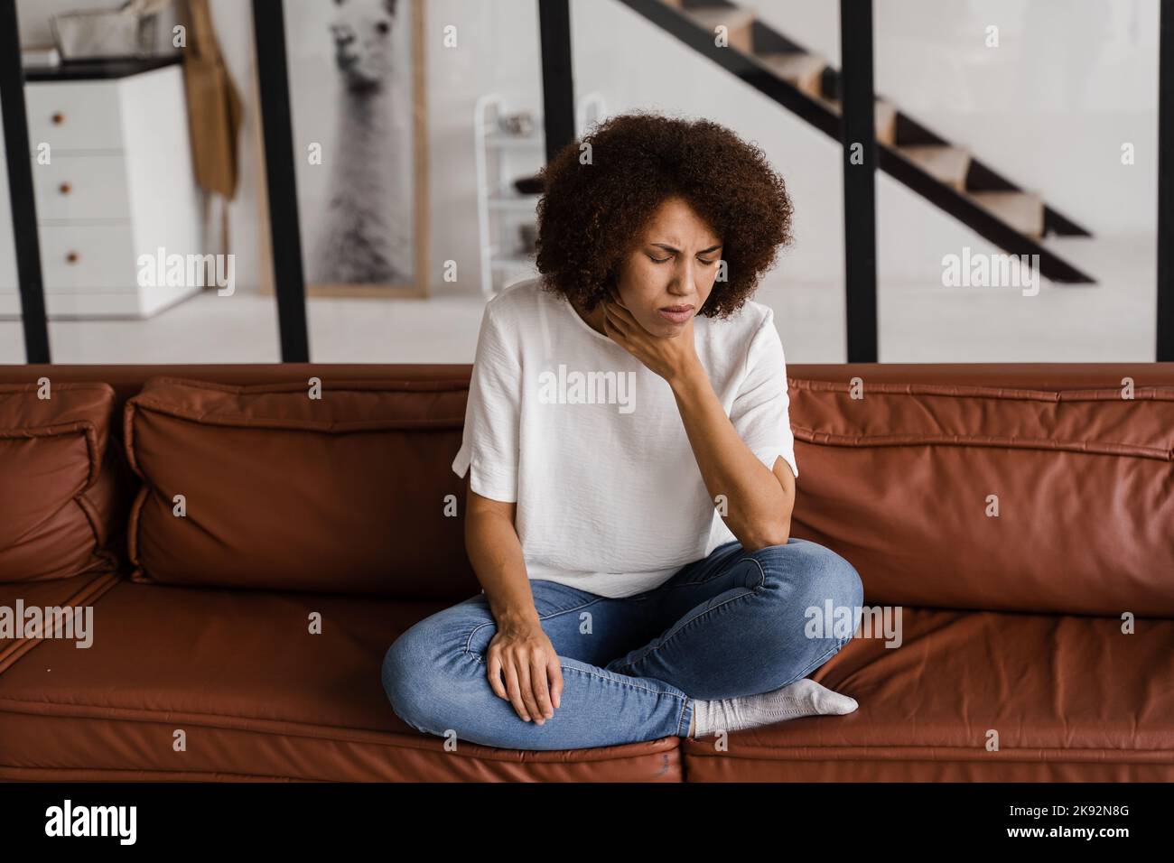 Laryngite premiers symptômes mal de gorge. Une fillette afro-américaine malade touche la gorge avec de la douleur. Maladie saisonnière médécine Banque D'Images