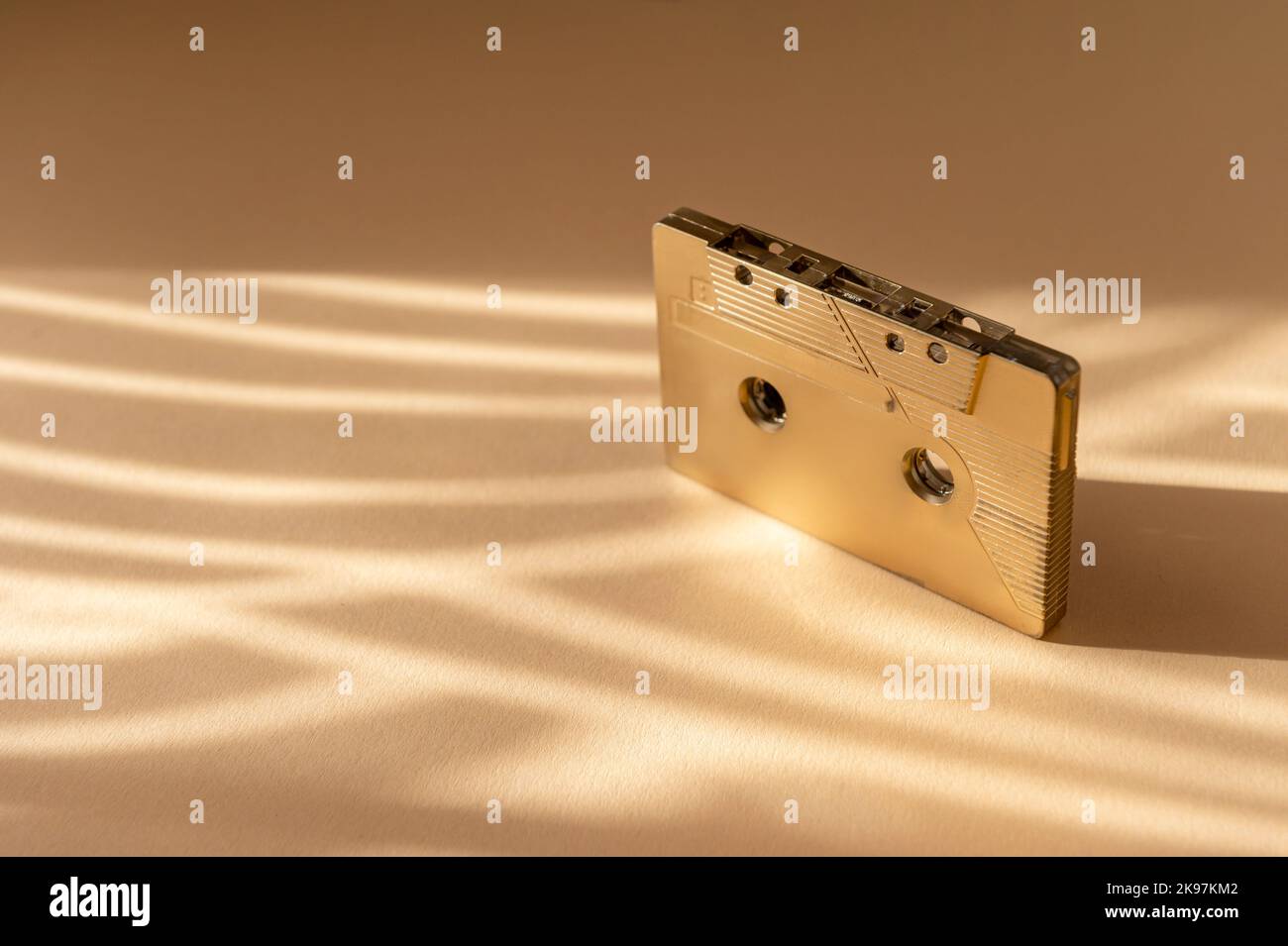 Cassette audio rétro dorée sur fond beige. Mixage rétro, 1980s cassettes pop et cassettes stéréo Banque D'Images