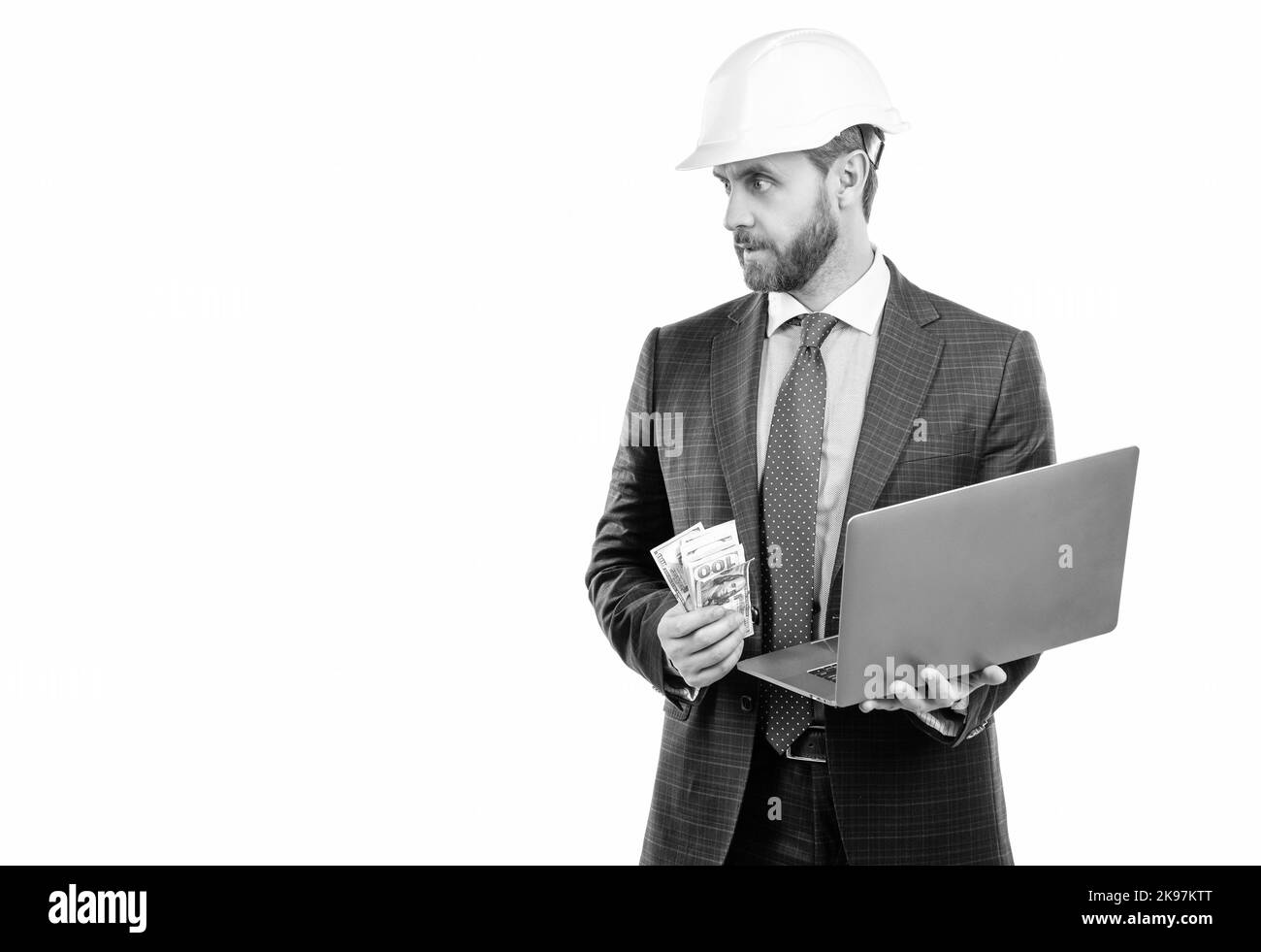 Homme ingénieur professionnel en casque et costume tenir l'argent et l'ordinateur portable, coût de travail Banque D'Images