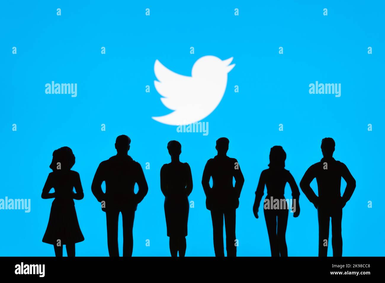Les silhouettes de figurine sont visibles devant le logo Twitter flou. Concept. Stafford, Royaume-Uni, 26 octobre 2022. Banque D'Images