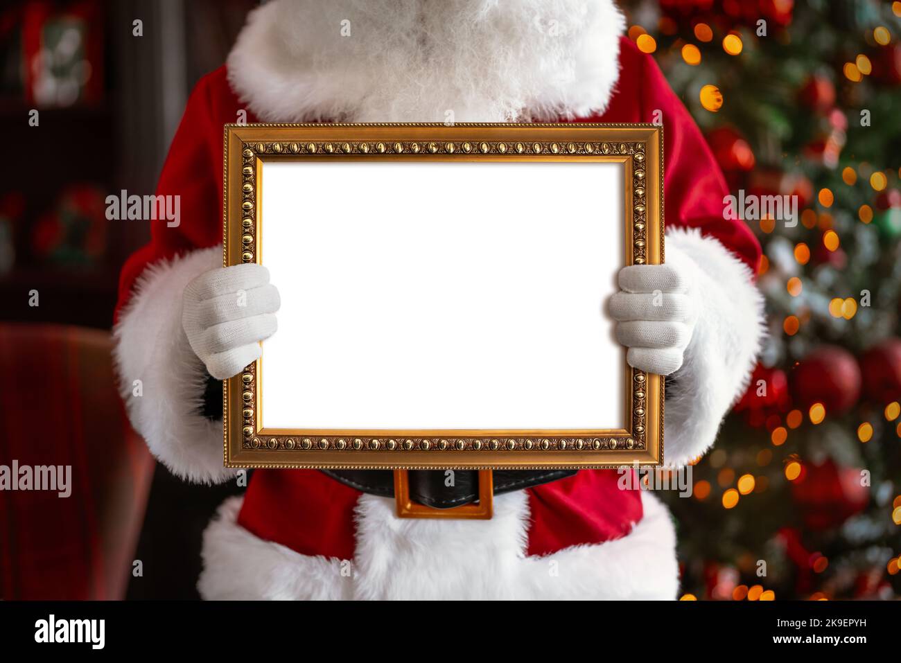 Le Père Noël tient le cadre blanc dans ses mains Banque D'Images