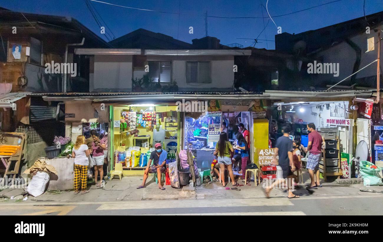 Une scène de rue nocturne typique dans un quartier animé de Cebu City, Philippines Banque D'Images
