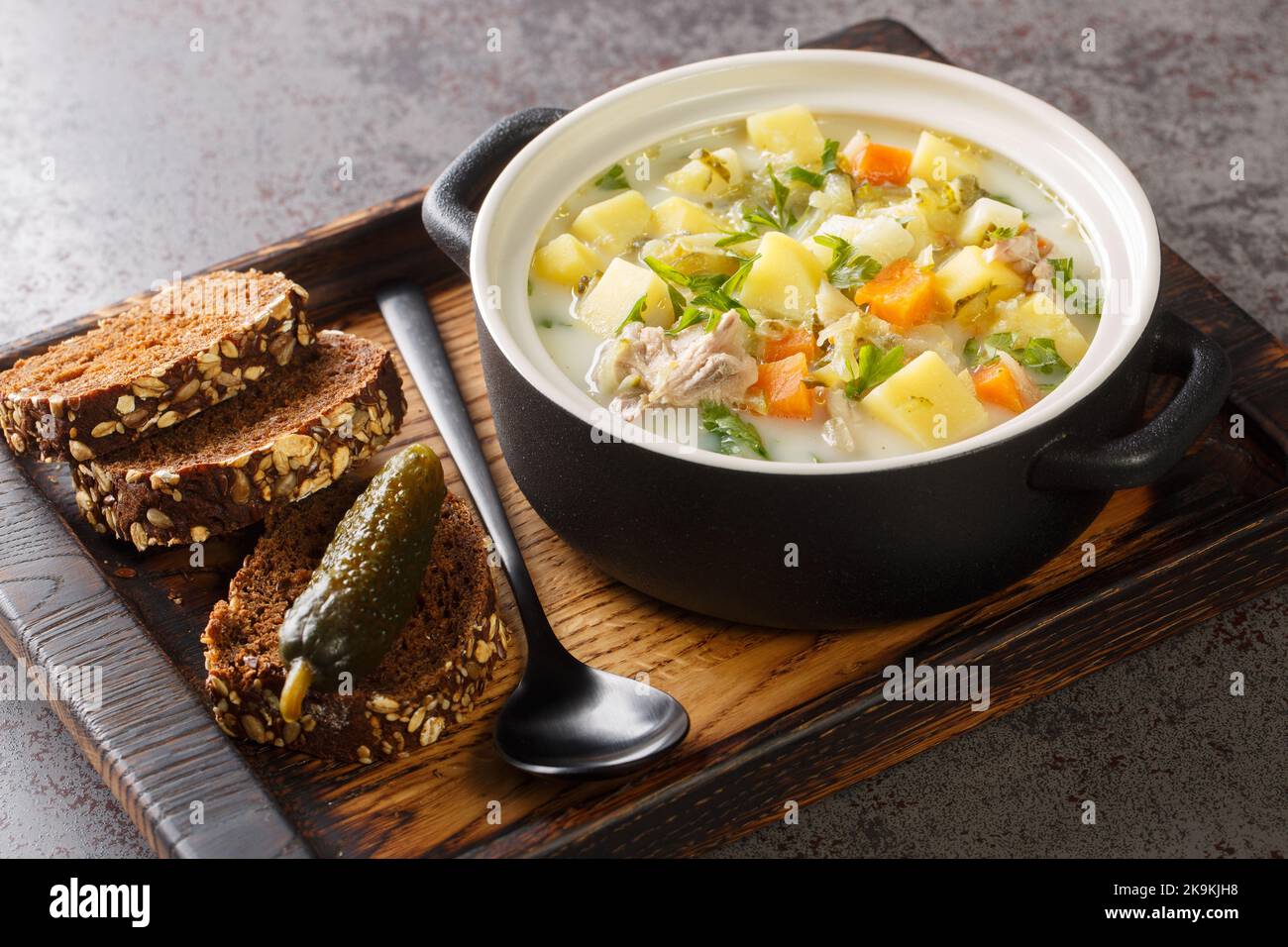 La soupe Zupa Ogorkowa Cucumber est une soupe traditionnelle polonaise et lituanienne à base de concombres et de légumes-racines aigre et salé, à proximité de la casserole sur le Banque D'Images