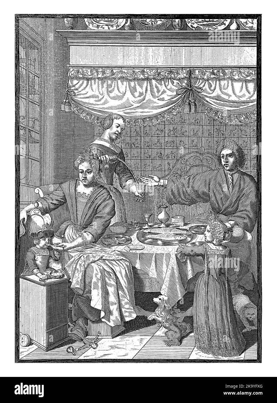 Dans un intérieur hollandais, une famille est assise sur une table où se trouve un bol de poisson, de pain, d'assiettes et de verres. Une femme de ménage verse un verre. Les parents sont sitti Banque D'Images