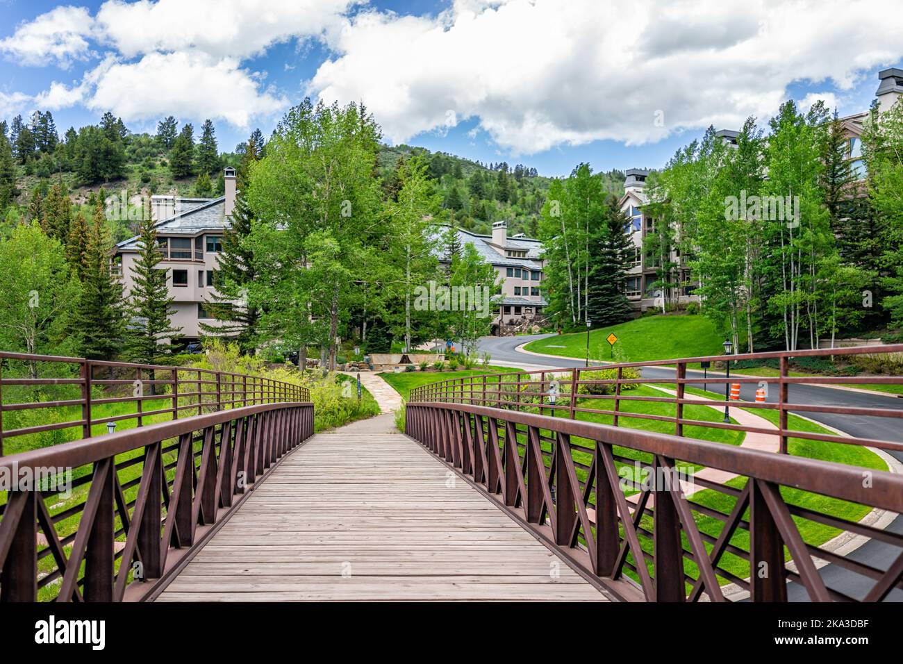 Passerelle piétonne sur le sentier de randonnée en boucle du village dans la station de ski de Beaver Creek de Vail près d'Avon, Colorado en été avec la forêt d'épinodes et Banque D'Images