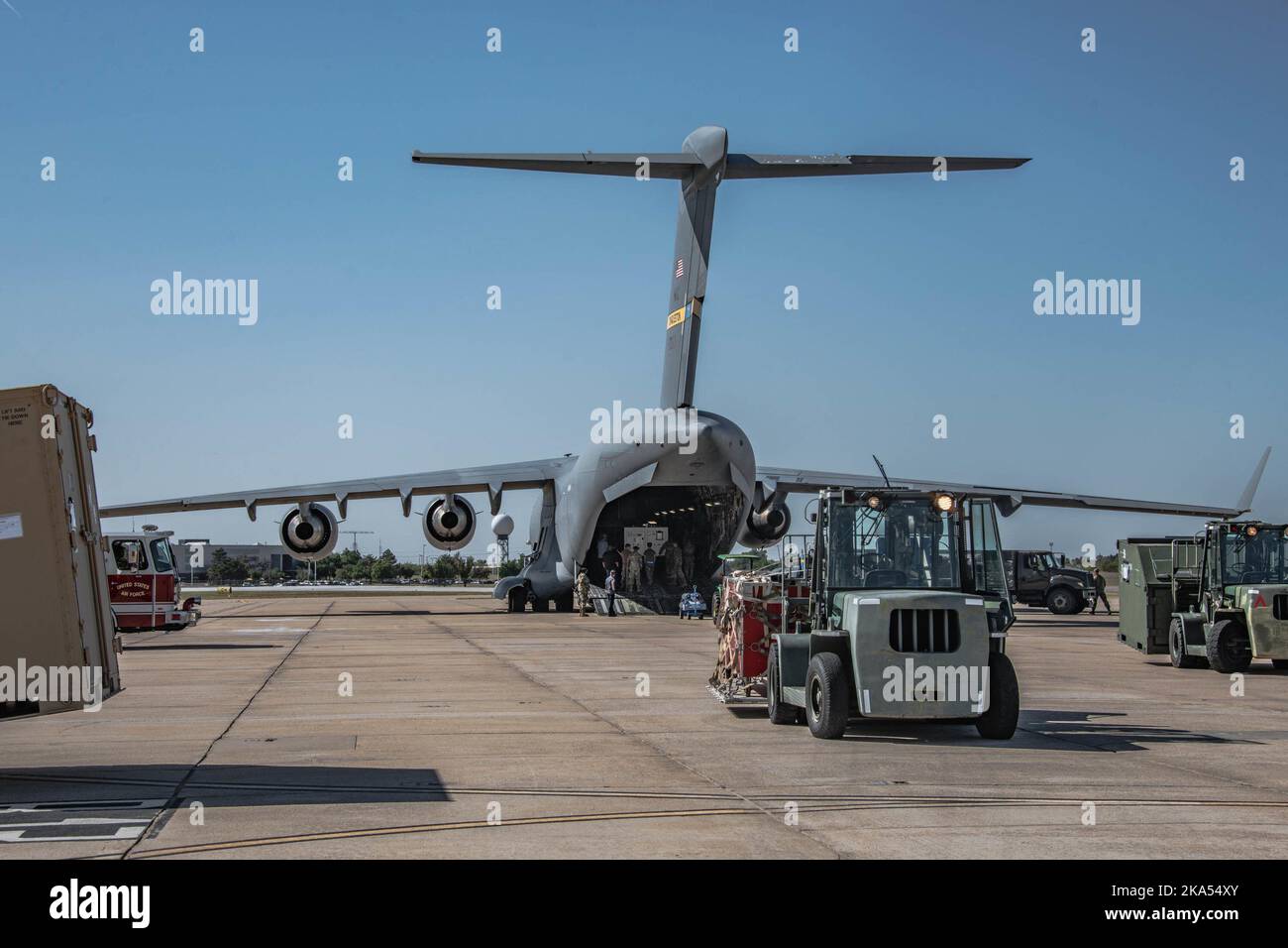 Des aviateurs de l'escadron de préparation logistique des opérations spéciales (SURLO) 137th, de la Garde nationale de l'Oklahoma, travaillent à charger et à ravitailler un C-17 Globemaster III, tandis que l'équipe des services d'urgence incendie 137th se tient prête sur la ligne aérienne de la base de la Garde nationale Will Rogers Air, Oklahoma City, le 13 octobre 2022. Le SRGL de 137th a reçu l'aide d'une équipe d'aviateurs de l'escadron d'intervention en cas d'urgence 321st de la base interarmées McGuire-dix-Lakehurst (New Jersey), tout en effectuant des mouvements de passagers et de fret et a également travaillé aux côtés de l'équipage actif et de réserve de la base interarmées de Charleston pour terminer l'opération. (É.-U. Banque D'Images