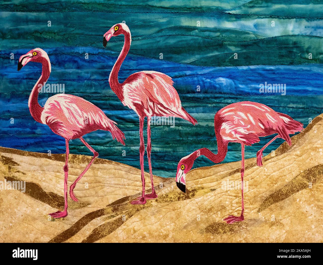 Une courtepointe d'illustration avec trois flamants roses sur une plage Banque D'Images