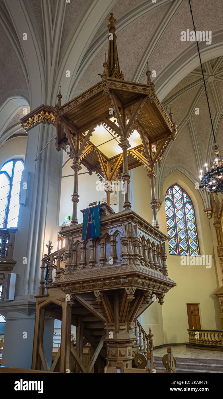 Finlande, Kotka - 18 juillet 2022 : Église paroissiale de Kotka-Kymin ou Seurakuntayhtymä. Gros plan de chaire sculptée en bois contre des piliers blancs et un mur jaune Banque D'Images