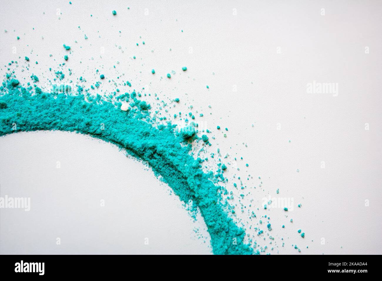 Tourbillon de poudre turquoise sur fond blanc Banque D'Images
