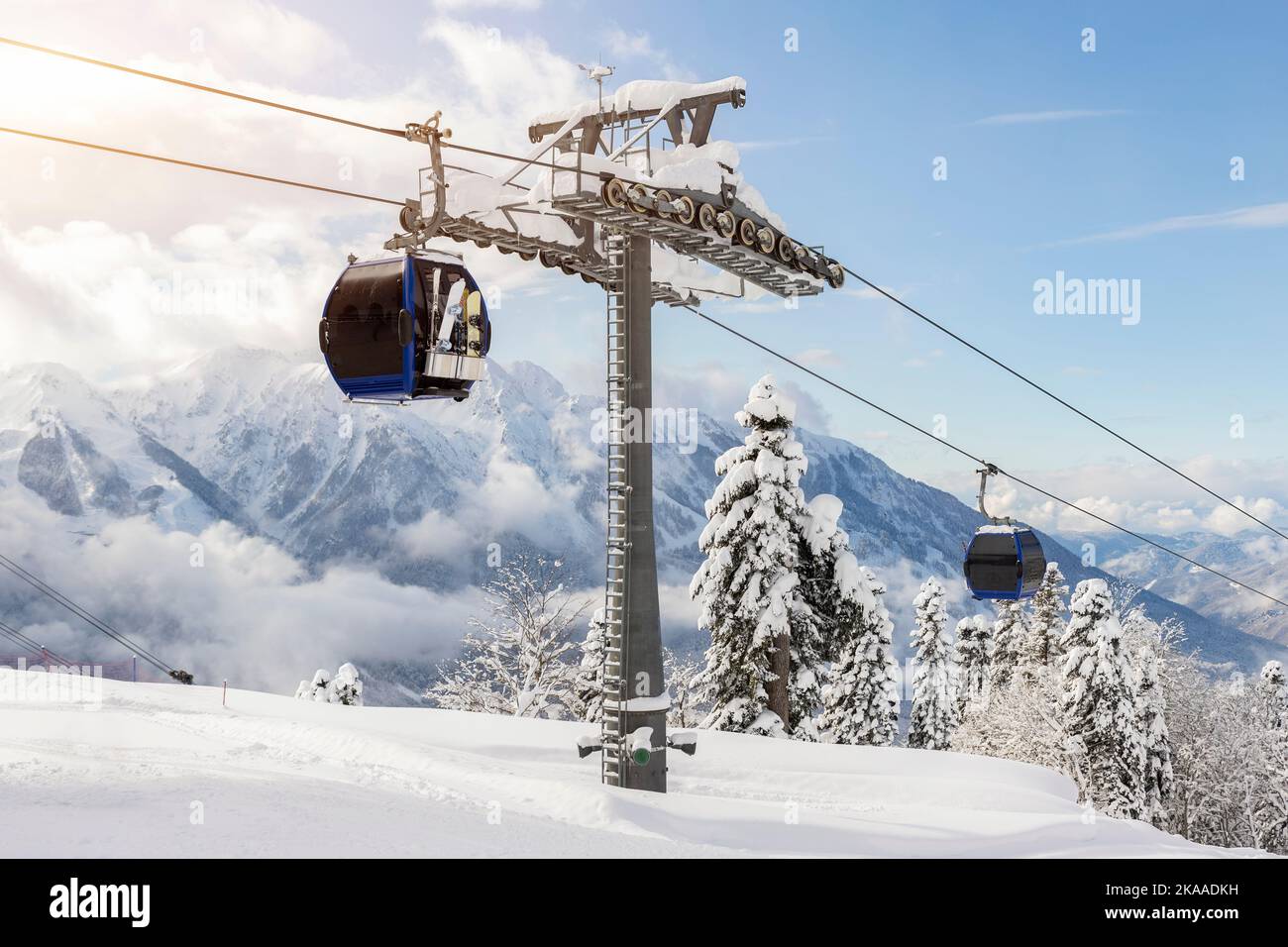 Nouvelle télécabine moderne et spacieuse, télécabine de ski contre les arbres forestiers enneigés et les sommets de montagne couverts de neige en hiver alpin de luxe Banque D'Images