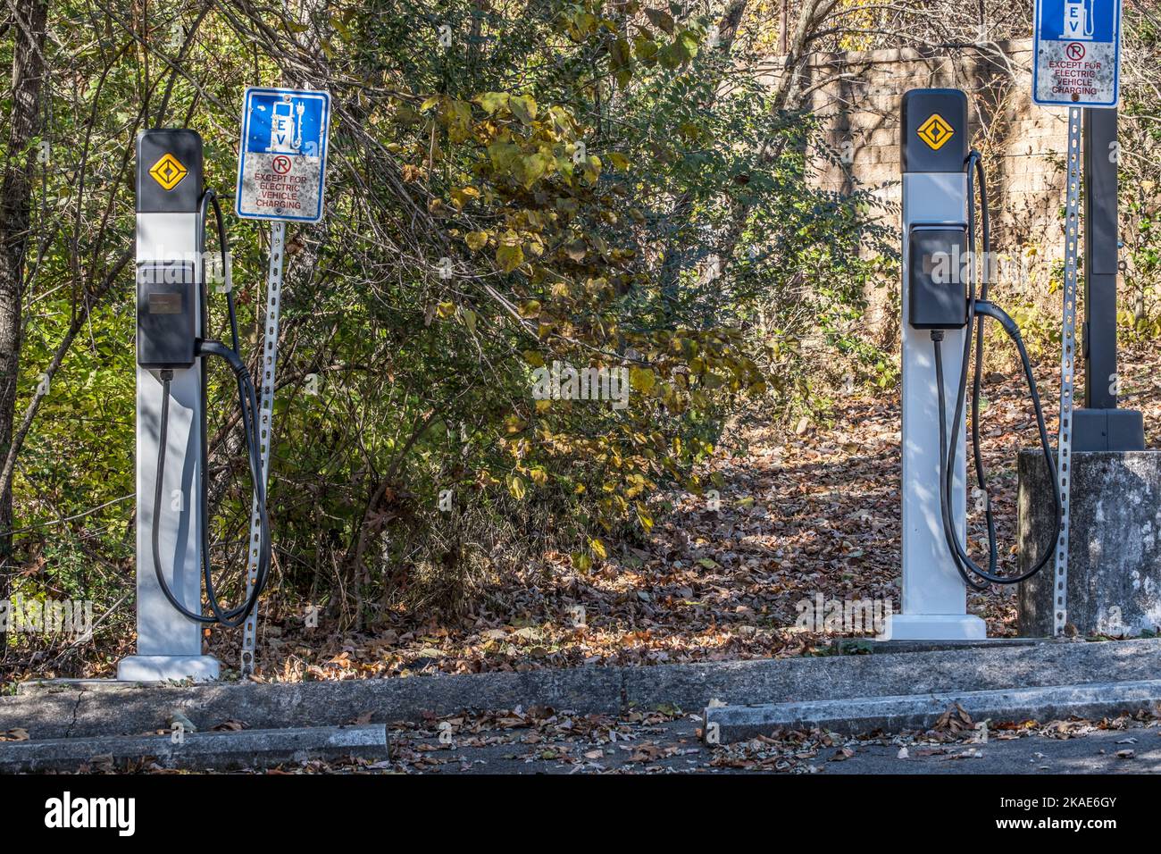 Deux postes de charge pour véhicules électriques avec signalisation à côté du stationnement uniquement pour les véhicules électriques à recharger dans un parc extérieur Banque D'Images