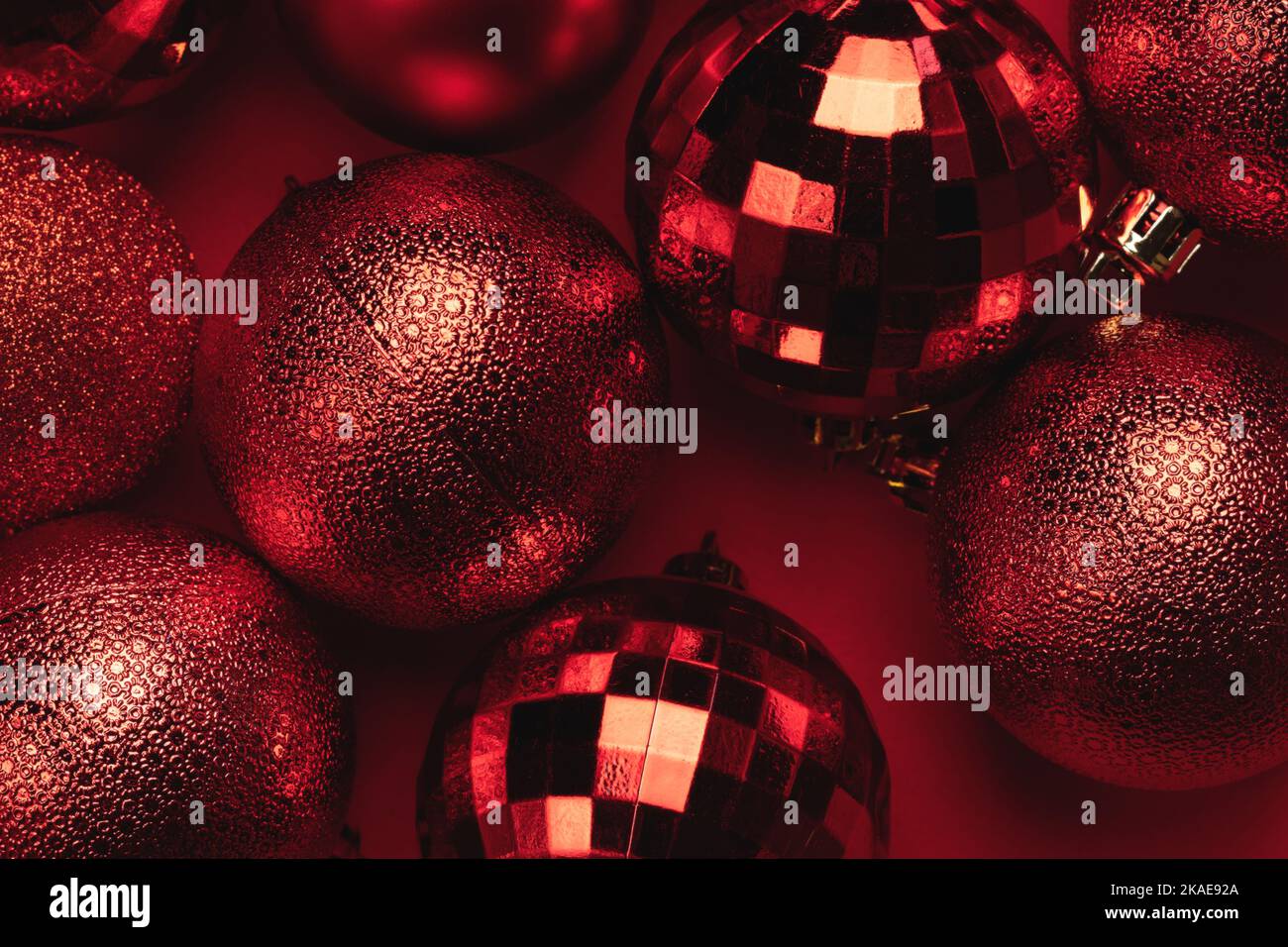 Carte de Noël avec boules rouges scintillantes sur fond rouge Banque D'Images