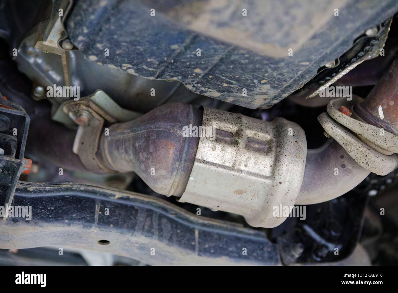 Gros plan sur le convertisseur catalytique d'une voiture moderne vue de dessous. Mise au point peu profonde. Banque D'Images Gros plan sur le convertisseur catalytique d'une voiture moderne vue de dessous. Mise au point peu profonde. Banque D'Images