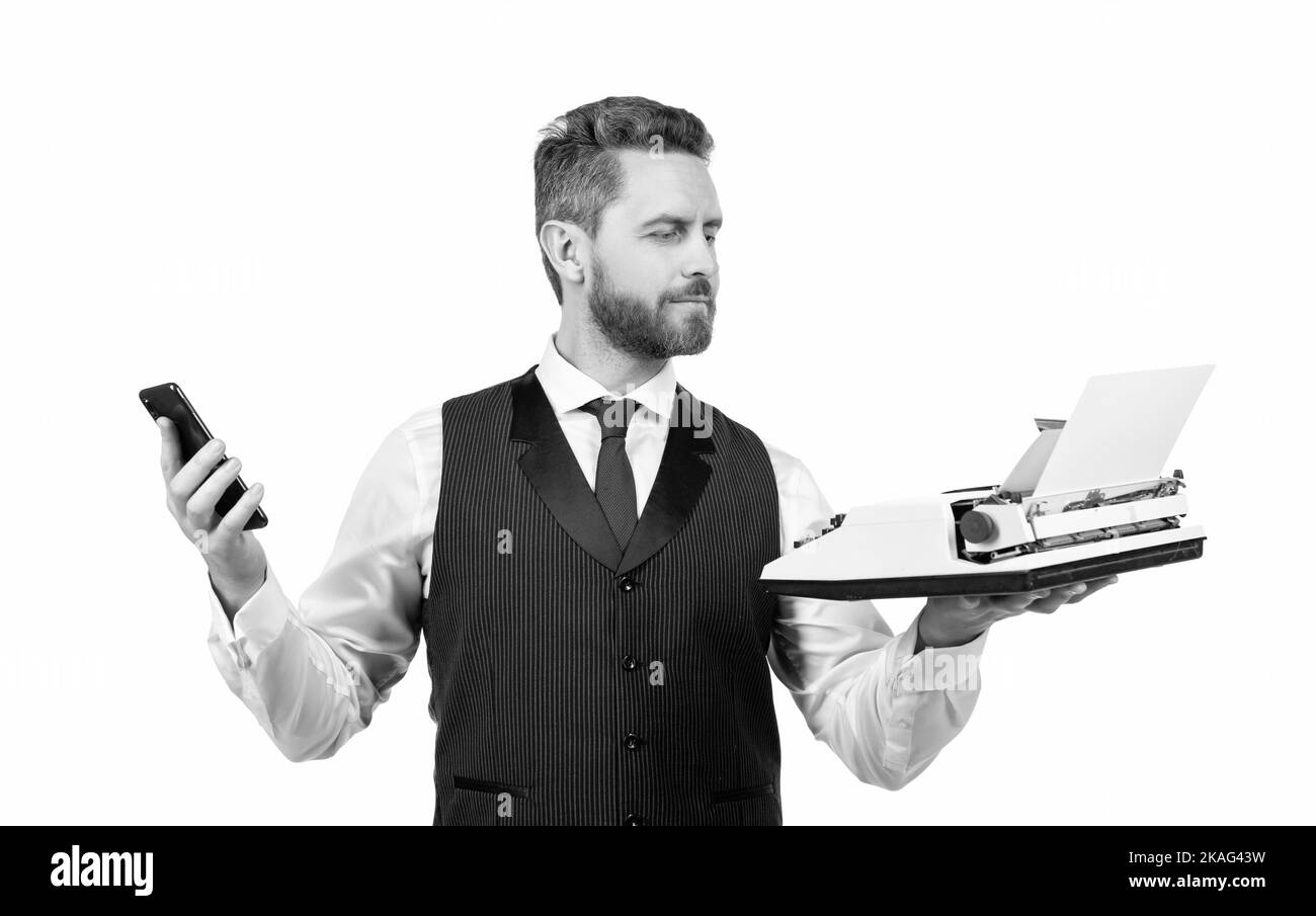 beau homme tient une machine à écrire rétro et un smartphone moderne, la technologie Banque D'Images