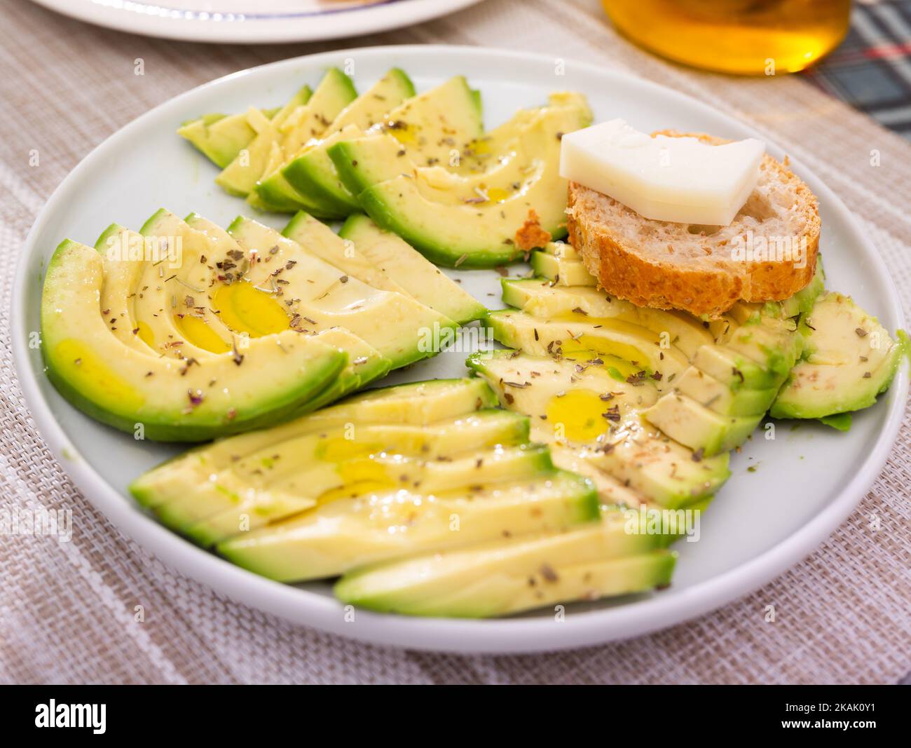 pulpe d'avocat mûre coupée en morceaux saupoudrée de jus de citron sur une assiette Banque D'Images