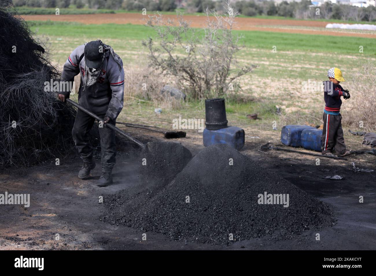 Un palestinien Ashraf Hillis travaille à la production d'un pigment noir destiné à être utilisé dans les matériaux de construction par la combustion de pneus de véhicules, dans la zone tampon à l'est de la ville de Gaza, le 25 janvier 2017. (Photo de Majdi Fathi/NurPhoto) *** Veuillez utiliser le crédit du champ de crédit *** Banque D'Images