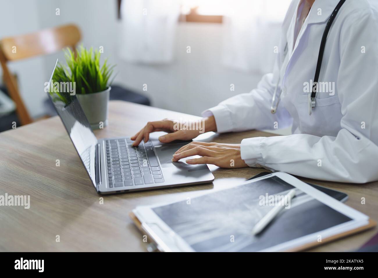 Portrait d'une femme asiatique médecin utilisant un ordinateur et une tablette pour travailler Banque D'Images