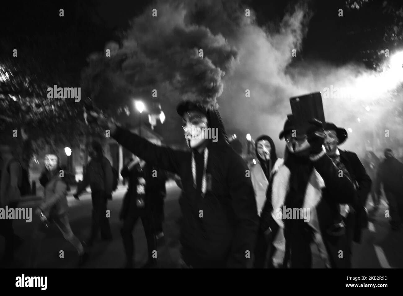 Des manifestants masqués descendent à Londres pour la million Mask March sur Bonfire Night, en agitant des drapeaux et des fusées éclairantes, Londres sur 5 novembre 2018. Dirigée par le groupe international de 'hactiviste' Anonyme, la manifestation anti-establishment voit les manifestants marcher à travers la capitale portant des masques Guy Fawkes. (Photo par Alberto Pezzali/NurPhoto) Banque D'Images