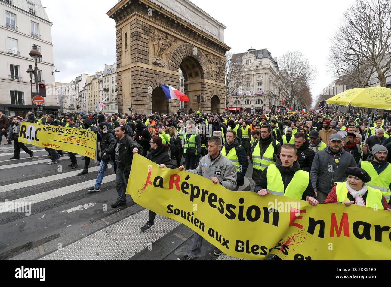 Les manifestants tiennent une bannerde lisant "la répression en marche" lors d'une manifestation anti-gouvernementale à Paris sur 26 janvier 2019 à l'appel du mouvement des Vêtes jaunes "Gilets Jaunes". Les manifestants anti-gouvernement « Yellow Vest » sont descendus dans les rues de France pour le samedi 11th consécutif sur 26 janvier, malgré les récentes divisions dans leurs rangs, Et avec une ténacité affichée face à un exécutif qui retrouve sa popularité dix jours après l'ouverture du « grand débat national », la tentative du président français de prouver qu'il prendra à son bord la critique féroce des manifestants « Yellow gilet » W Banque D'Images