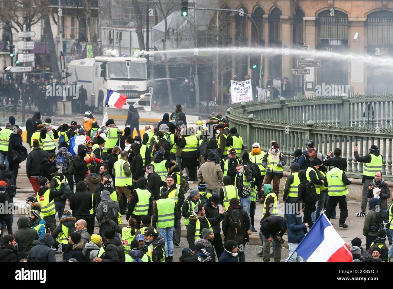 Un véhicule de police vaporise du canon à eau sur les manifestants lors d'une manifestation antigouvernementale à Paris sur 26 janvier 2019, organisée par le mouvement des gilets jaunes « Gilets Jaunes ». Les manifestants anti-gouvernement « Yellow Vest » sont descendus dans les rues de France pour le samedi 11th consécutif sur 26 janvier, malgré les récentes divisions dans leurs rangs, Et avec une ténacité affichée face à un exécutif qui retrouve sa popularité dix jours après l'ouverture du « grand débat national », la tentative du président français de prouver qu'il prendra à son compte la critique féroce des manifestants « gilets jaunes » qui ont été renvers Banque D'Images