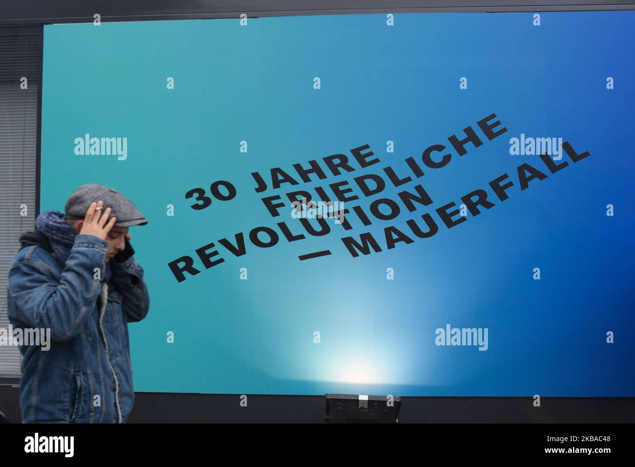 Un visiteur marche à côté d'un panneau '30 Jahre friedliche révolution - Mauerfall' ('30 années de révolution pacifique - chute du mur'), vu près d'une partie d'une section encore debout de l'ancien mur de Berlin appelée East Side Gallery, À la veille du prochain anniversaire de la chute du mur de Berlin en 30th. L'Allemagne marque trois décennies depuis la chute du mur de Berlin cette semaine avec les principales célébrations dans la capitale allemande samedi, 9 novembre 2019. Vendredi, 8 novembre 2019, à Berlin, en Allemagne. (Photo par Artur Widak/NurPhoto) Banque D'Images